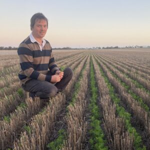Matt Rohde inspecting soil and crops